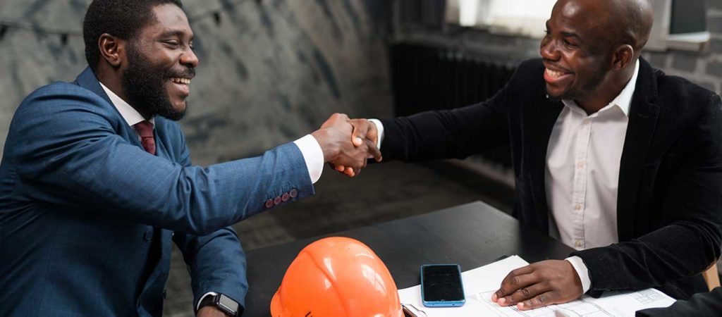Two African American architects shaking hands - TrebleHook Customer Relationship Management