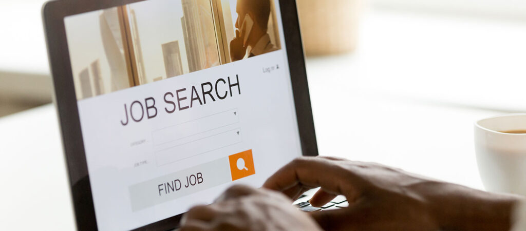 A person searching a job search website on a laptop.